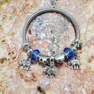 Stretches silver colored metal charm bracelet